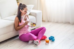 athletic woman eating healthy food